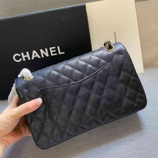 This is CHANEL Caviar Quilted Small Double Flap in Black. This shoulder bag is crafted of luxurious diamond-quilted caviar leather in black.