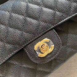 This is CHANEL Caviar Quilted Small Double Flap in Black. This shoulder bag is crafted of luxurious diamond-quilted caviar leather in black.