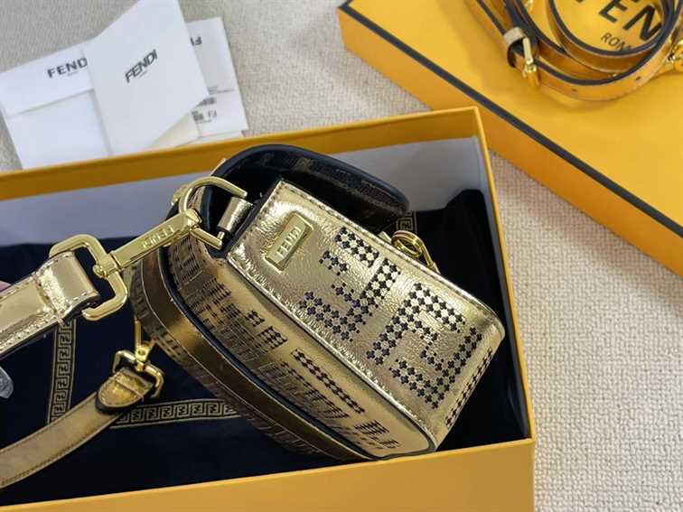 Iconic, boxy mini Baguette bag from the Versace by Fendi collection. Made of gold-coloured leather with FF motif gold laser-cut perforations that create an effect that evokes the Versace metal mesh.