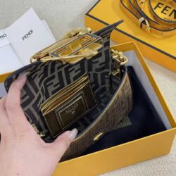 Iconic, boxy mini Baguette bag from the Versace by Fendi collection. Made of gold-coloured leather with FF motif gold laser-cut perforations that create an effect that evokes the Versace metal mesh.