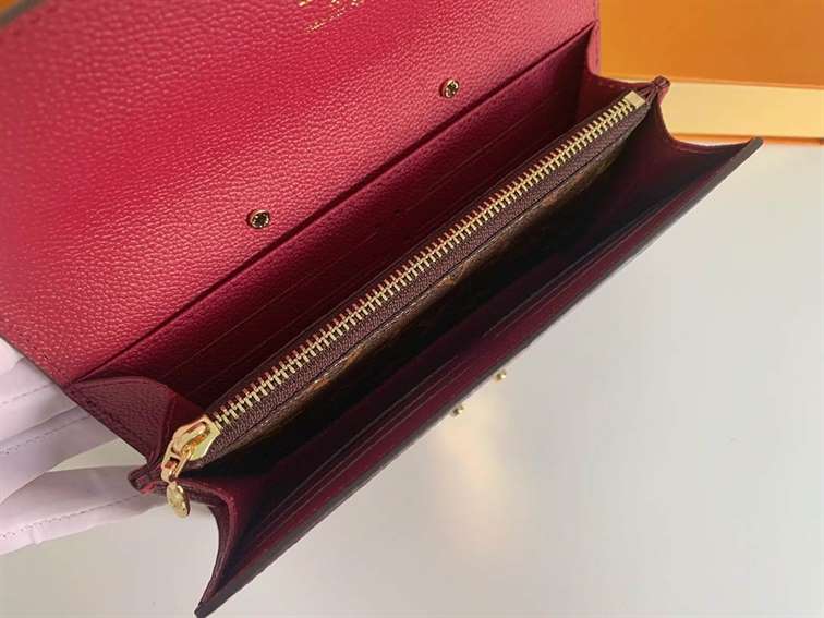 LV wallet in burgundy and Hermes wallet in tan brown